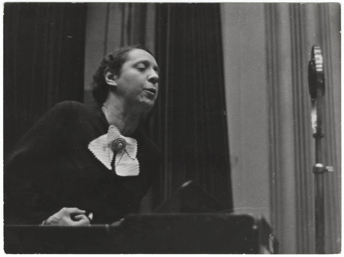 [Marguerita Nelkery, Spanish worker's deputy, addressing a meeting from a podium, Paris, France]
