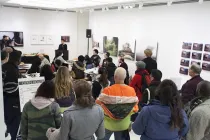 A photo of a group of people watching a presentation.