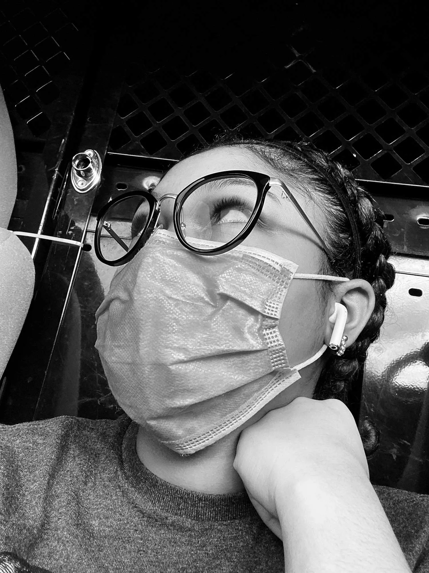 A girl looking away with a face mask.