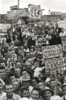 Black and white photograph of crowd of people holding signs at a rally