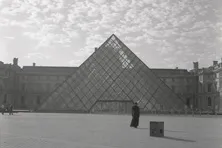 A man in front of a triangle building.