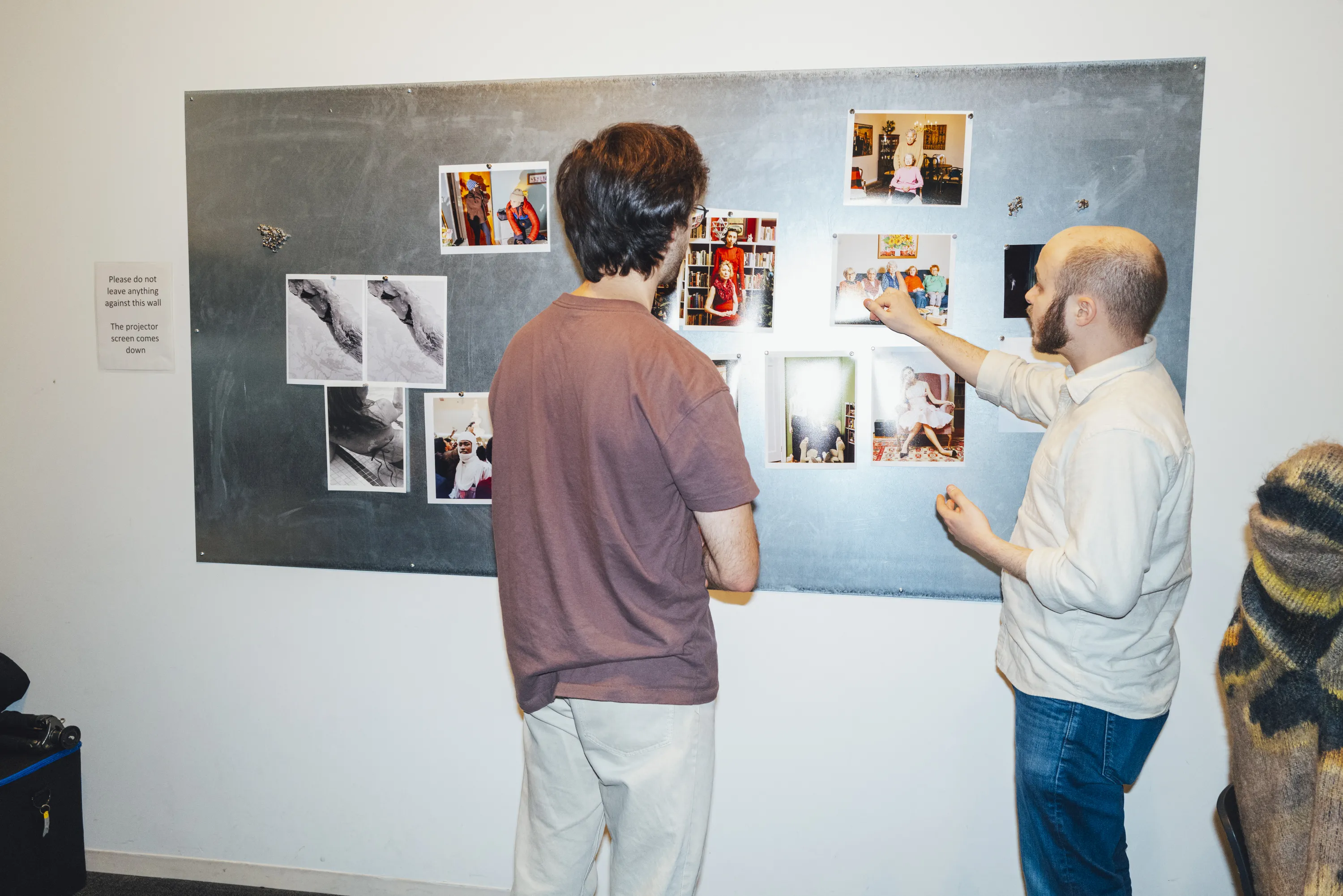 Instructor and student looking at images on a magnetic board